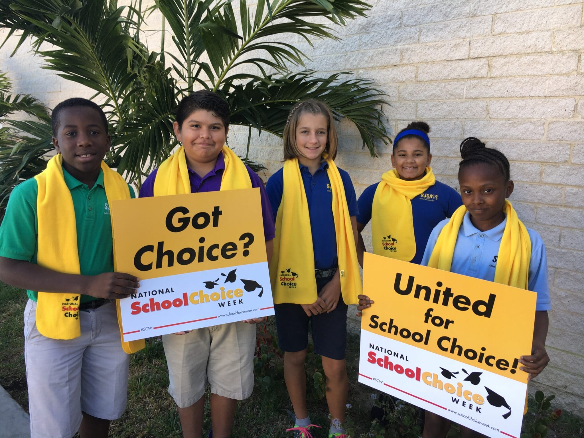Students holding school choice signs