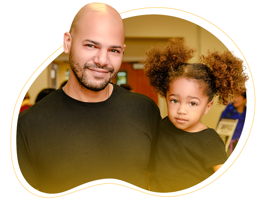 A father and a daughter side-by-side smiling