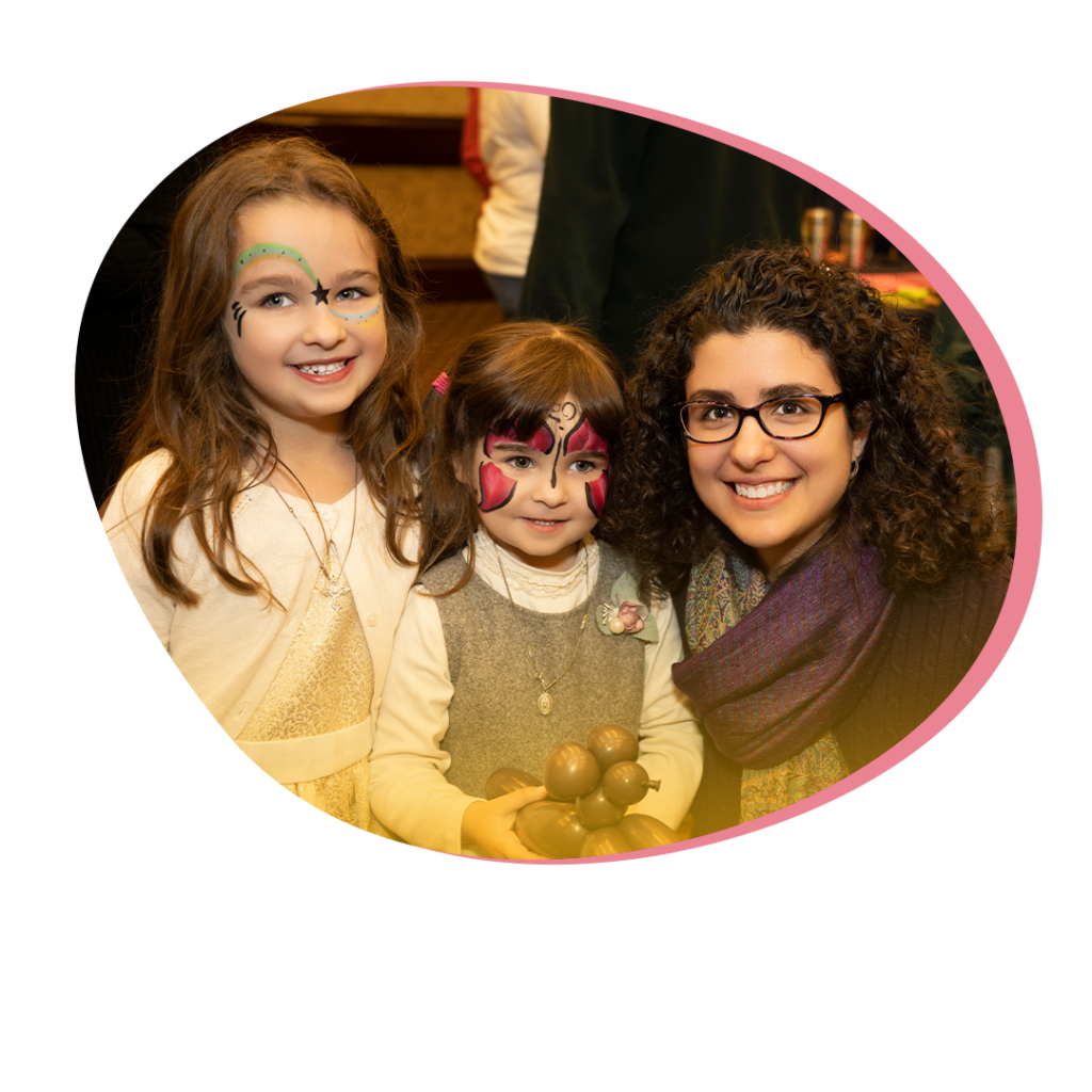 A mother with her two daughters who have face paint on