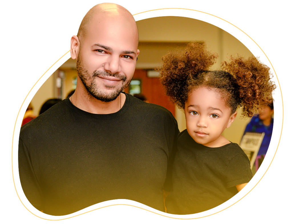 A father and a daughter side-by-side smiling