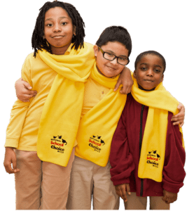 Three grade school kids side-by-side wearing yellow National School Choice Week scarves