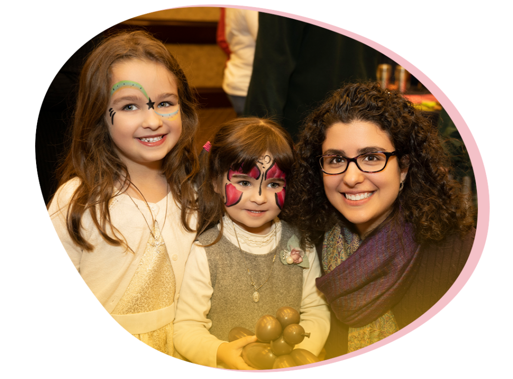 A mother with her two daughters who have face paint on